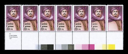2250a, 22c Enrico Caruso, black (engraving) omitted, the far right stamp in a showpiece bottom sheet-margin transitional strip of seven, the first five stamps completely normal,
while the sixth stamp has just part of the black engraving missing,